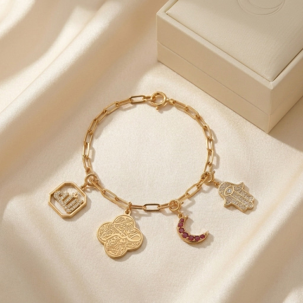 Habiba charm bundle — 18K gold bracelet, four charms, and signature gift box